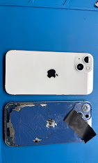 An iPhone with a new back glass next to the cracked original